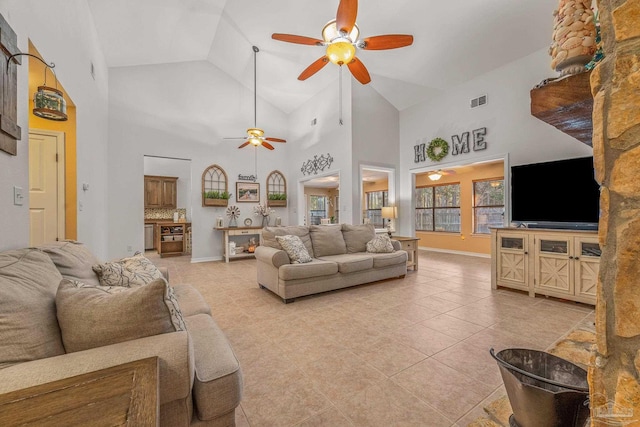 living room featuring light tile patterned floors, ceiling fan, visible vents, and baseboards