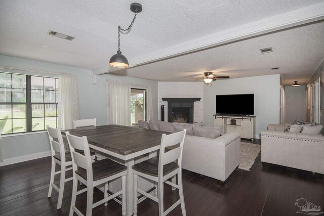 living area with a textured ceiling, ceiling fan, and hardwood / wood-style floors