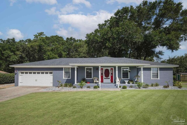 single story home with covered porch, a garage, and a front lawn