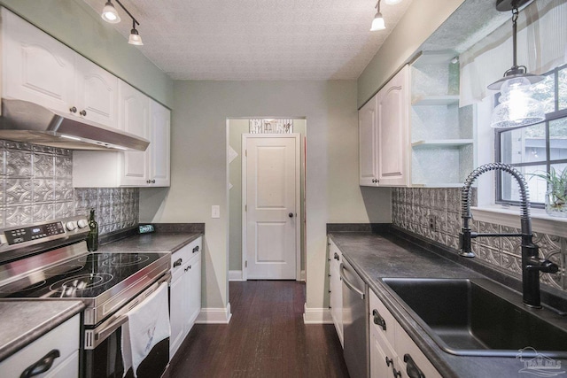 kitchen with sink, white cabinetry, a textured ceiling, stainless steel appliances, and decorative backsplash