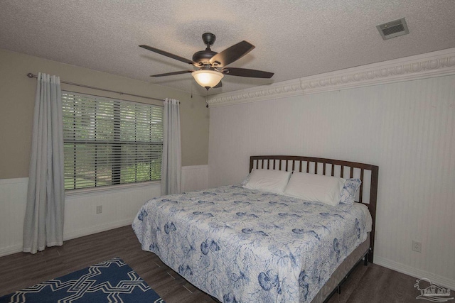 bedroom featuring ceiling fan, light wood-type flooring, and a textured ceiling