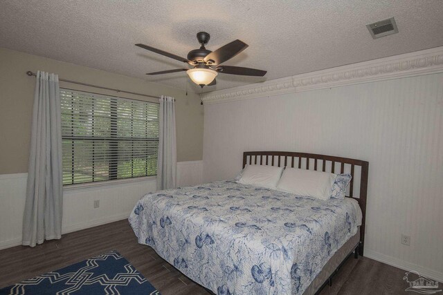 tiled bedroom featuring ceiling fan, connected bathroom, and a textured ceiling