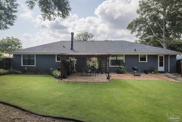 rear view of property featuring a yard