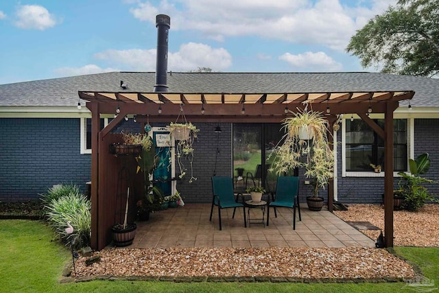 back of property with a pergola and a patio