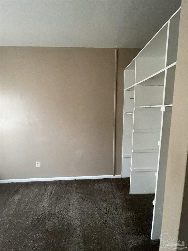 interior space featuring dark colored carpet