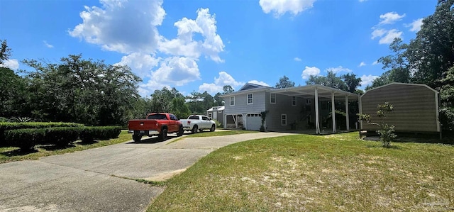 view of side of home featuring concrete driveway and a yard