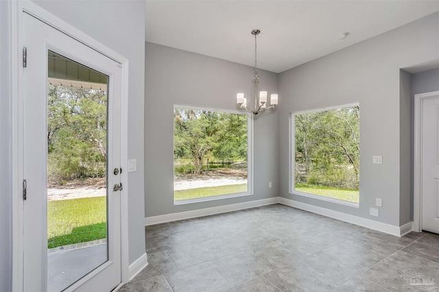 unfurnished dining area with a notable chandelier