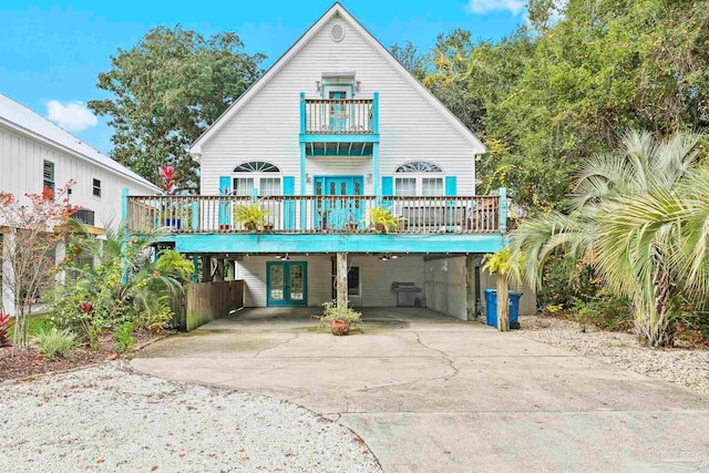 rear view of property featuring french doors and a carport