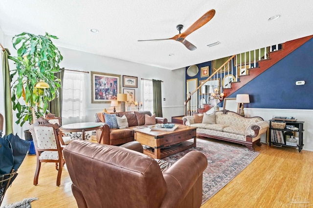 living room featuring ceiling fan and light wood-type flooring