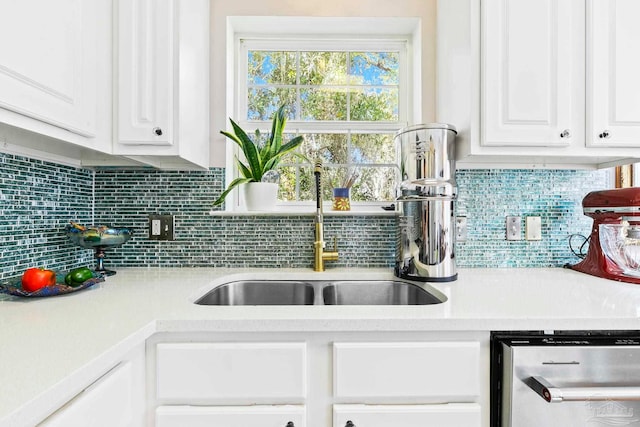 kitchen with backsplash, white cabinetry, sink, and dishwasher