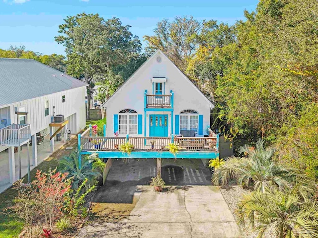 view of front of home with a balcony and a carport