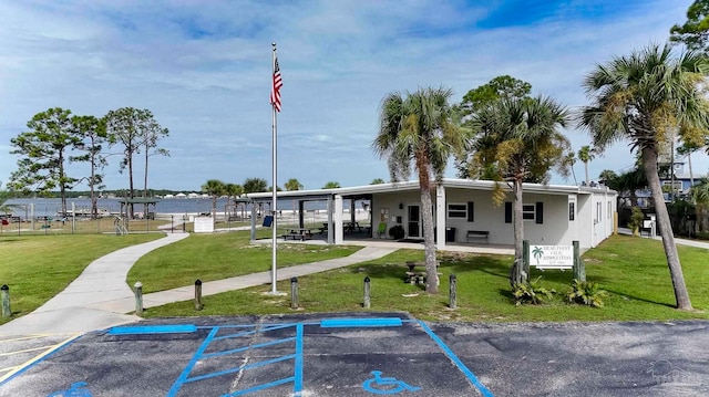 view of community featuring a yard and a water view