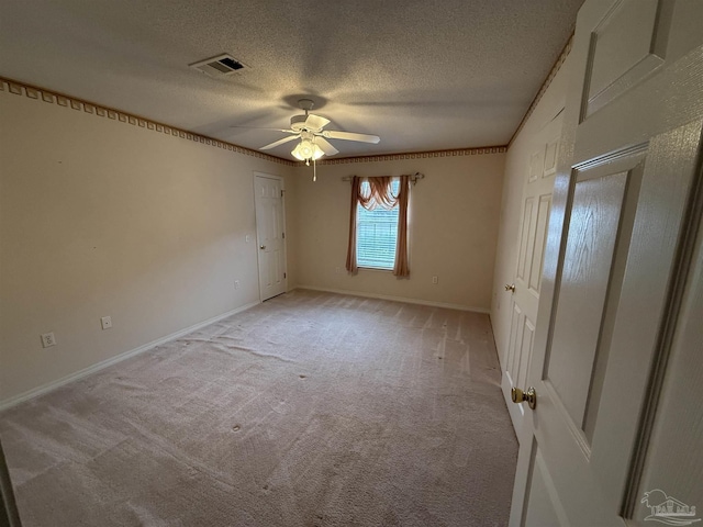 unfurnished bedroom featuring visible vents, a ceiling fan, a textured ceiling, baseboards, and light colored carpet