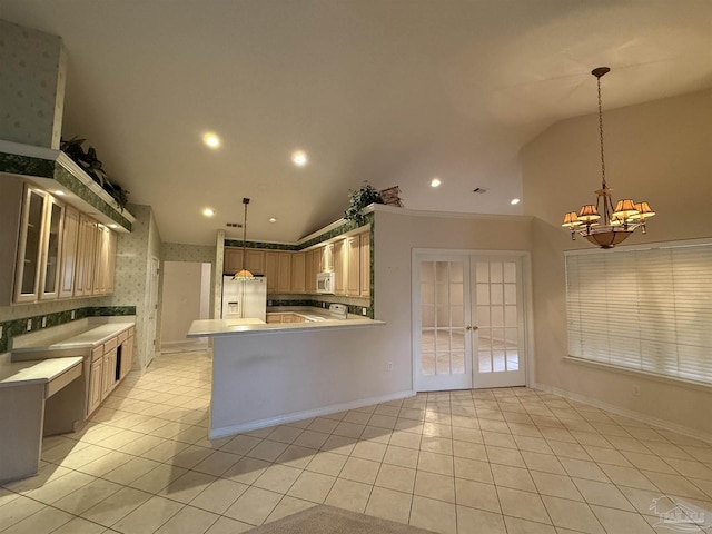 kitchen with white appliances, an inviting chandelier, lofted ceiling, light tile patterned flooring, and french doors