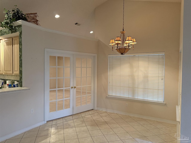 unfurnished dining area with baseboards, visible vents, french doors, crown molding, and a chandelier