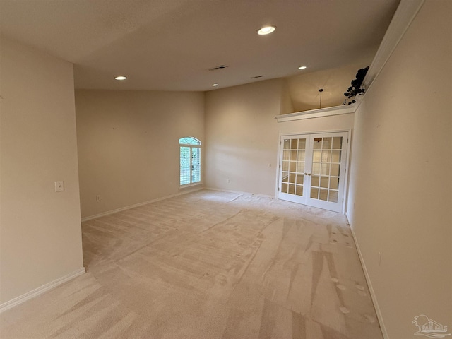 empty room featuring recessed lighting, french doors, light colored carpet, and visible vents