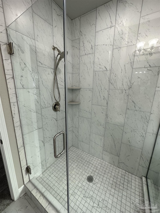 bathroom featuring a shower with shower door