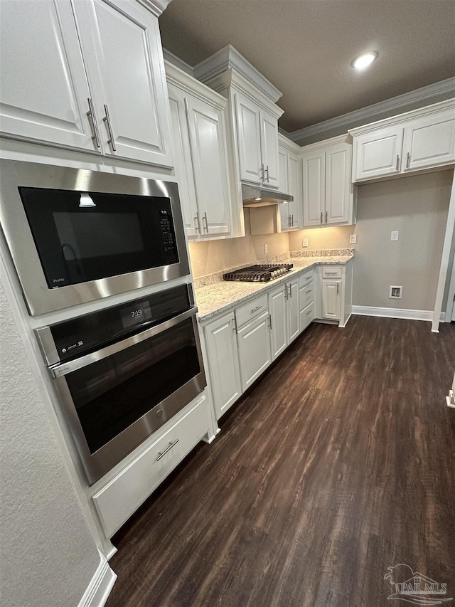 kitchen featuring crown molding, stainless steel appliances, dark hardwood / wood-style floors, light stone countertops, and white cabinets