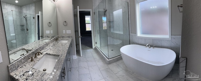 bathroom featuring vanity and shower with separate bathtub