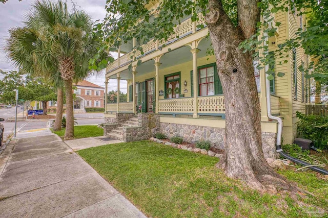 view of front of home featuring a front lawn and a porch