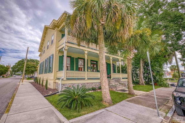 view of property exterior featuring covered porch