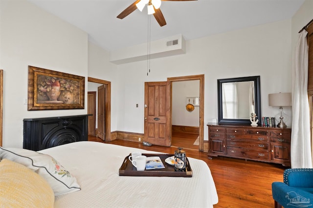 bedroom with lofted ceiling, hardwood / wood-style floors, and ceiling fan