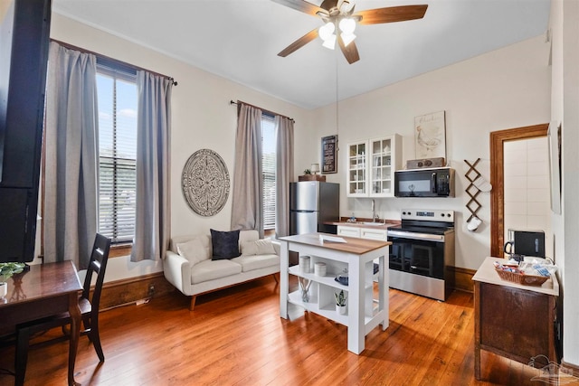 office with ceiling fan, sink, and light hardwood / wood-style floors