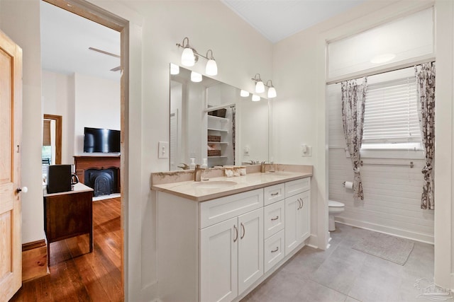 bathroom with hardwood / wood-style floors, vanity, and toilet