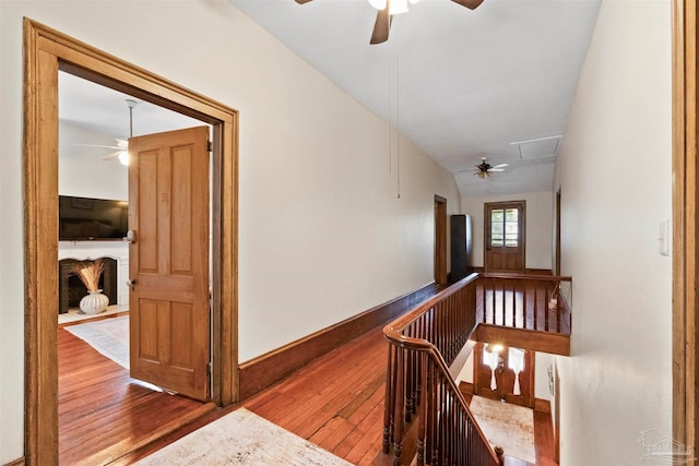 hall featuring lofted ceiling and hardwood / wood-style floors