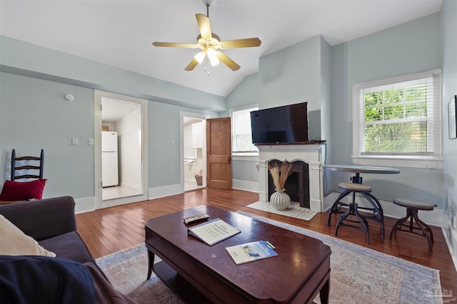 living room with lofted ceiling, ceiling fan, and hardwood / wood-style floors