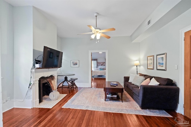 living room featuring ceiling fan and hardwood / wood-style floors