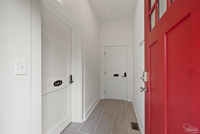 hallway featuring tile patterned flooring