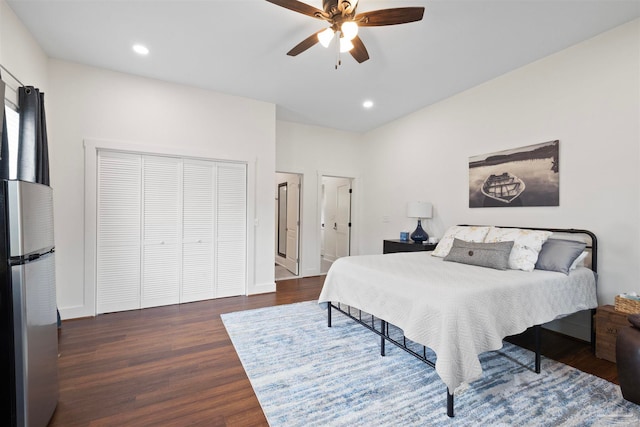 bedroom with ceiling fan, stainless steel refrigerator, and dark hardwood / wood-style flooring