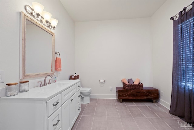 bathroom with vanity, toilet, and tile patterned floors