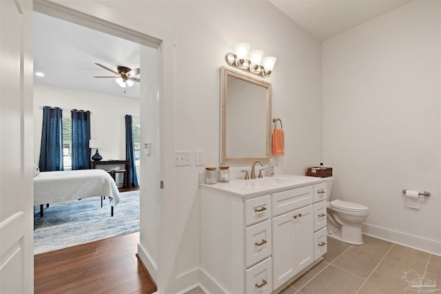 bathroom featuring vanity, ceiling fan, hardwood / wood-style floors, and toilet