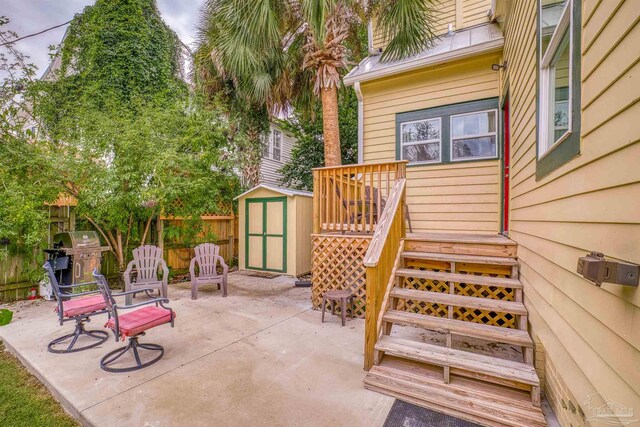 view of patio / terrace with grilling area and a storage unit