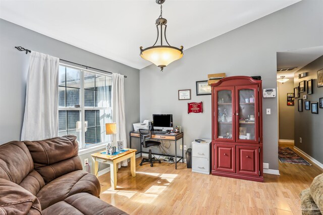 home office with baseboards, visible vents, and light wood finished floors