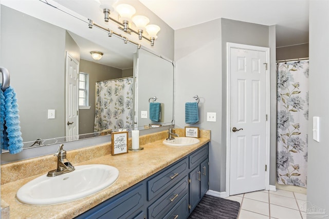 full bathroom with double vanity, tile patterned flooring, and a sink