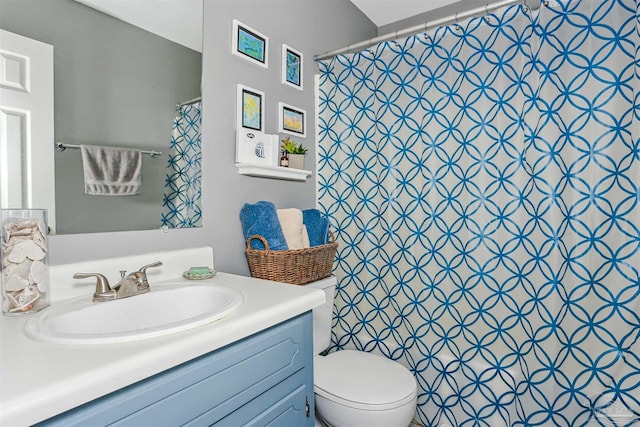 bathroom with toilet, vanity, and a shower with shower curtain
