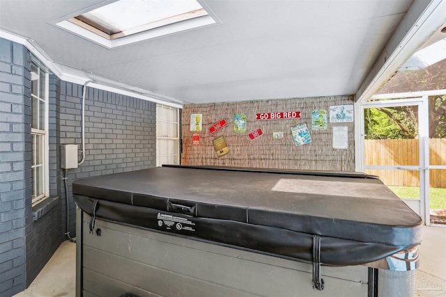 misc room featuring concrete flooring, plenty of natural light, and a skylight