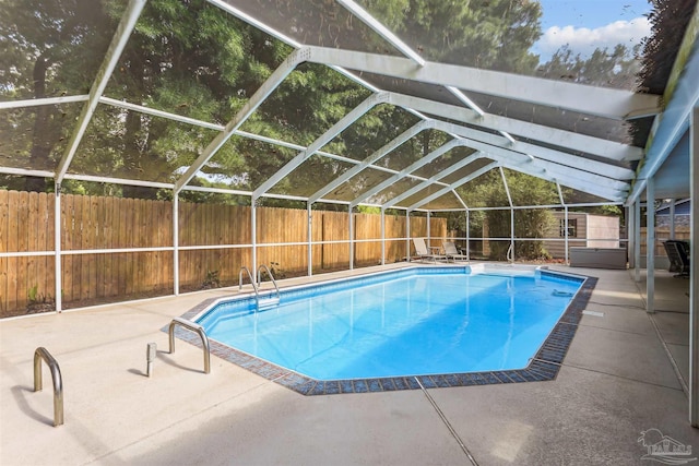 view of pool featuring a fenced backyard, a fenced in pool, glass enclosure, and a patio