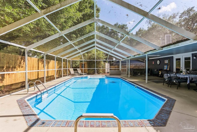 view of swimming pool with a lanai, a fenced backyard, a fenced in pool, and a patio