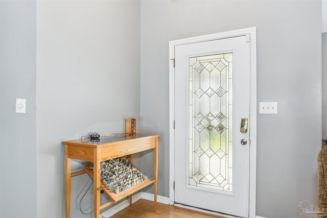 entryway with wood finished floors and baseboards