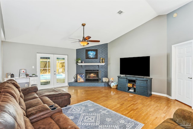 living room featuring vaulted ceiling, wood finished floors, ceiling fan, french doors, and visible vents