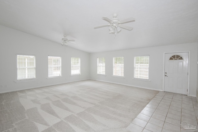 unfurnished living room featuring ceiling fan, lofted ceiling, and light carpet