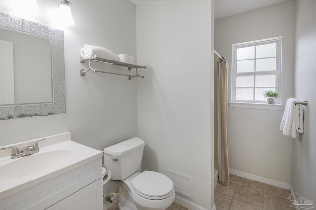 bathroom featuring vanity, tile patterned flooring, and toilet