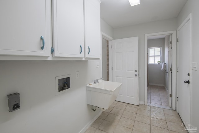 laundry area with washer hookup, sink, cabinets, and light tile patterned flooring