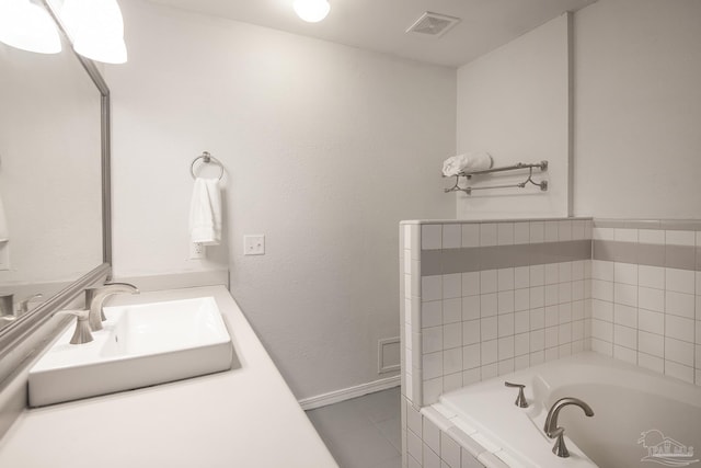 bathroom with a relaxing tiled tub and vanity