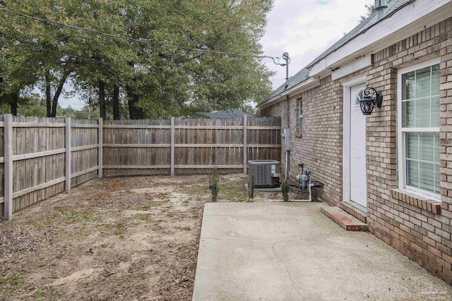 view of yard featuring central AC and a patio area