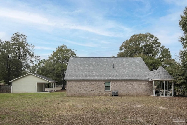 view of property exterior with central AC unit and a yard